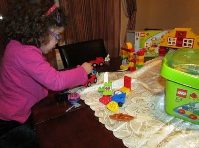 Girl playing with LegoDuplo
