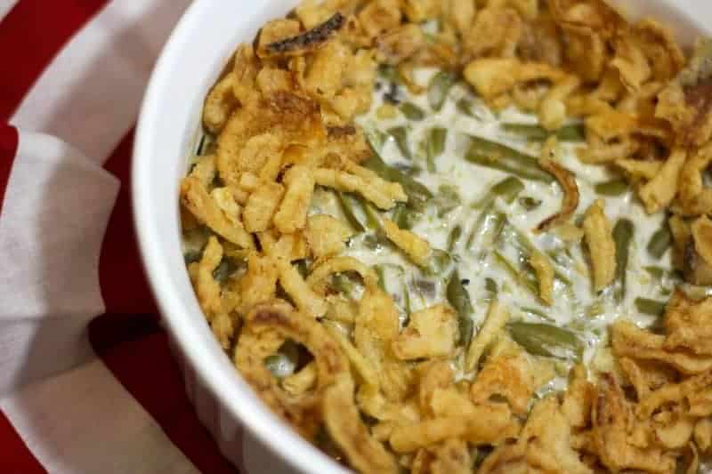 Looking for a great Christmas side dish recipe to sneak healthy veggies into your holiday meal? Try this yummy green bean casserole with fried onions!