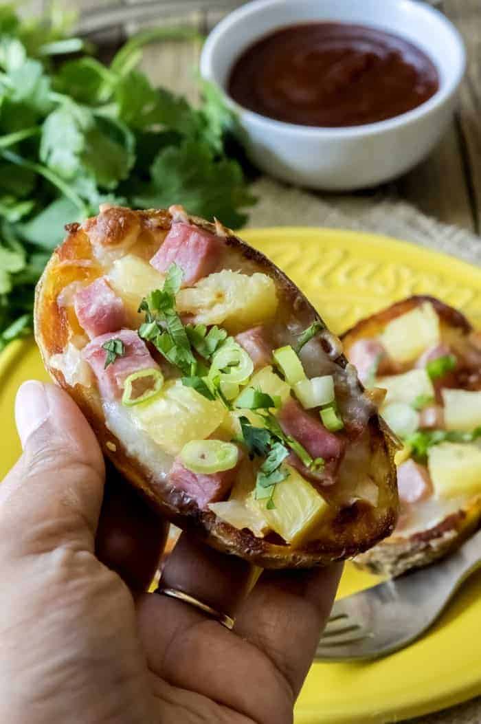 This Hawaiian potato skin recipe is a tasty gluten-free twist on Hawaiian pizza! Makes a unique Thanksgiving side dish or appetizer for your Christmas party!
