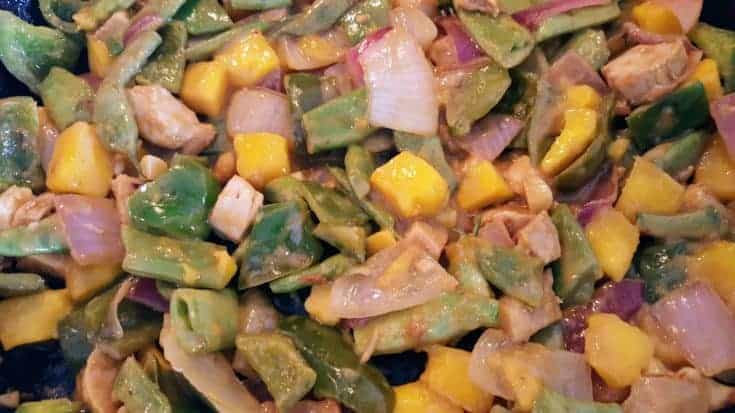 an image of chicken and mango stir fry
